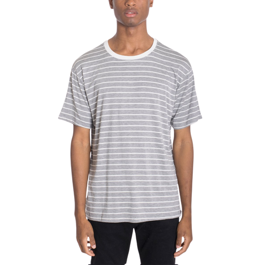 Man wearing a striped shirt with arms crossed on a white background