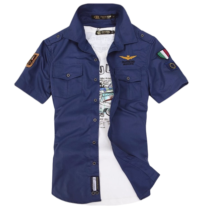 Blue short-sleeve shirt with patches on a white background