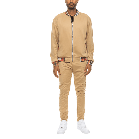 Men's two-piece Version Couture track suit with zip-up jacket and matching pants, featuring checkered detail on the collar, cuffs, and waistband.
