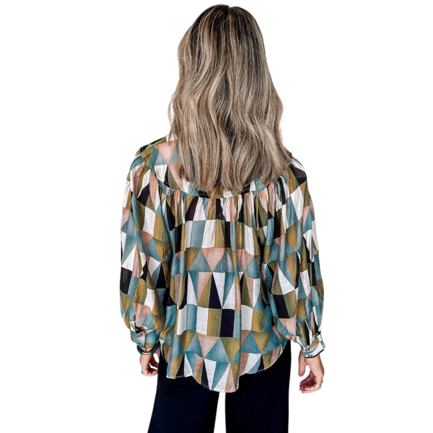 Woman wearing a geometric patterned blouse on a white background