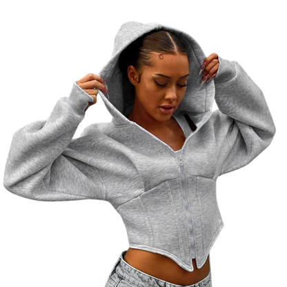 Woman wearing a gray cropped hoodie on a white background