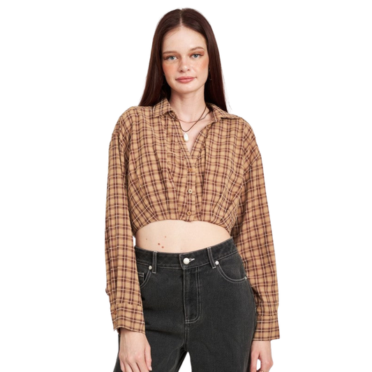 Woman wearing a plaid shirt and black jeans on a white background