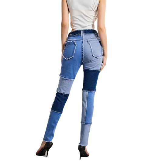 Blue patchwork jeans worn by a person on a white background